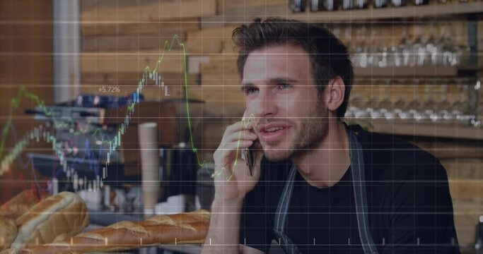 Animation of multiple graphs with numbers over caucasian male barista talking on cellphone at cafes
