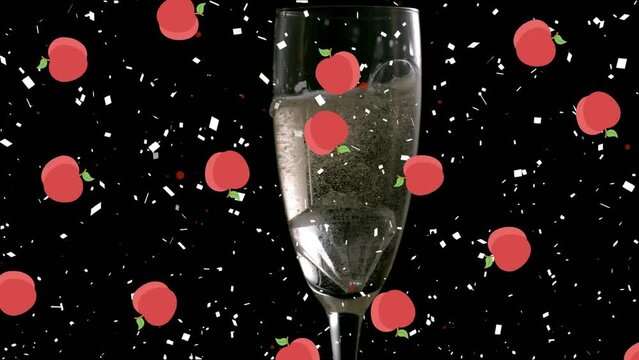 Animation of apples and confetti over glass of champagne