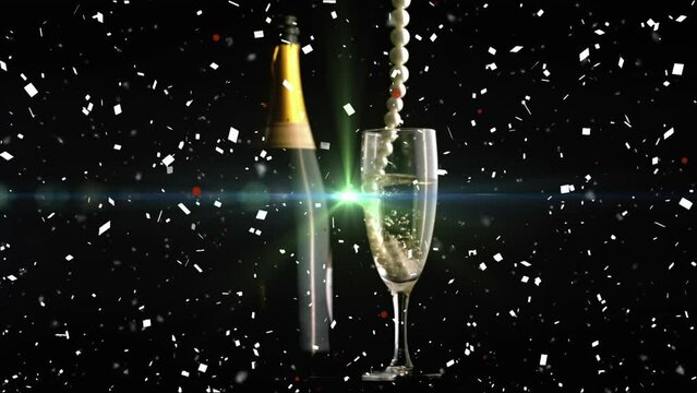 Animation of necklace and confetti over glass of champagne