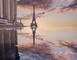 Eiffel Tower reflected in a puddle at sunrise. Paris, France
