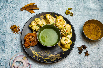 Chicken Reshmi tikka boti kabab with melted butter and chili sauce served in a dish isolated on grey background top view of bangladesh food