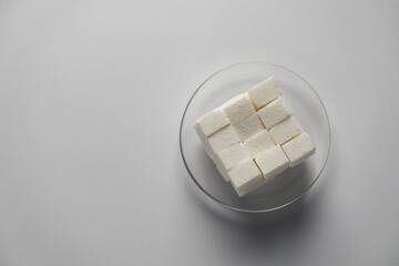 Sugar cubes in white bowl shot directly above isolated on white background with clipping path. High quality photo