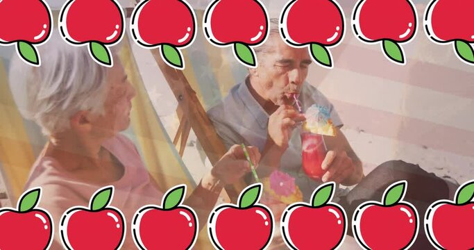 Animation of apple icons over senior caucasian couple at beach