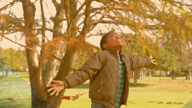 Animation of african american boy playing in park over leaves