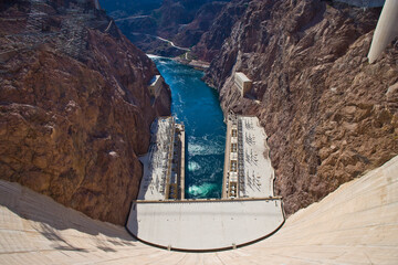 Hoover Dam powerhouse with the Colorado River flowing down Black canyon.