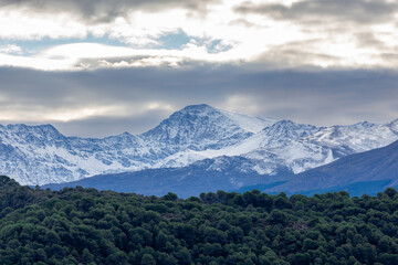 Fototapeta na wymiar View of the snowy Mulhacen in Sierra Nevada; It is the highest peak in the Iberian Peninsula