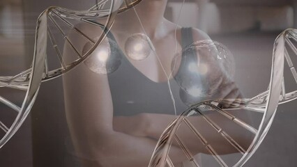 Animation of dna strand and light spots over biracial woman exercising - Powered by Adobe