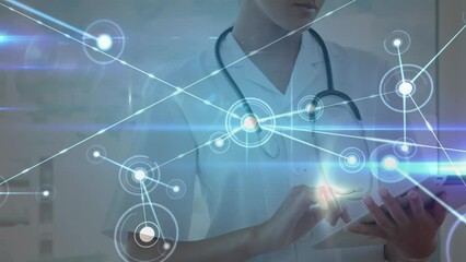 Animation of illuminated dots connected with lines over biracial female doctor using digital tablet - Powered by Adobe