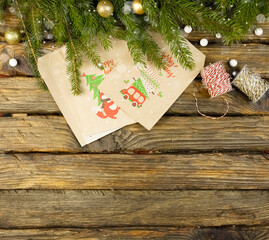 Advent calendar envelopes on the background of Christmas tree twigs, space for copy. Beautiful festive background with highlights, blurred lights. Christmas card with Advent calendar