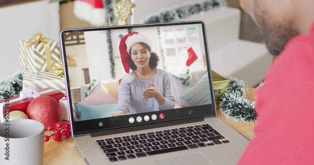 Poster African american man with christmas decorations having video call with biracial woman