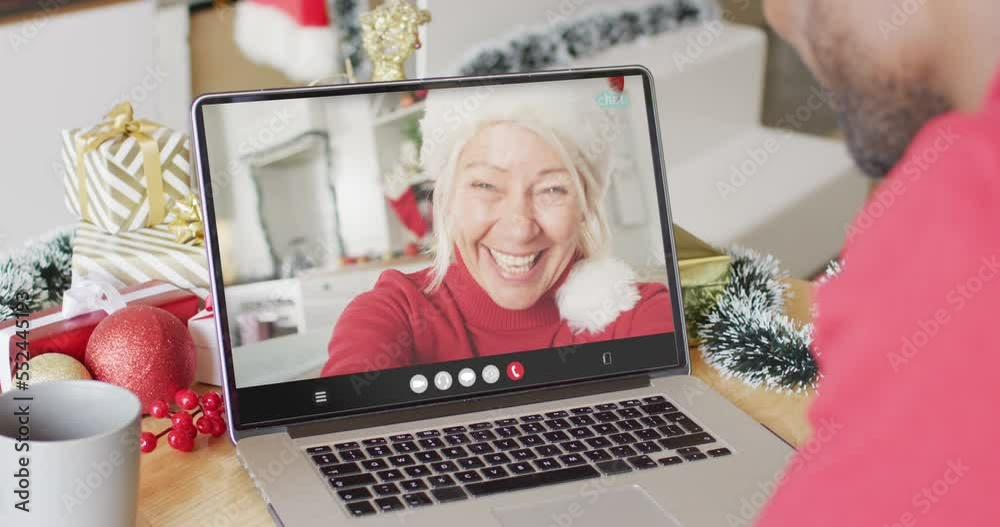 Poster African american man with christmas decorations having video call with caucasian woman