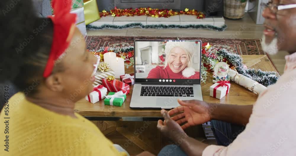 Poster Animation of senior biracial couple on laptop video call with woman at christmas