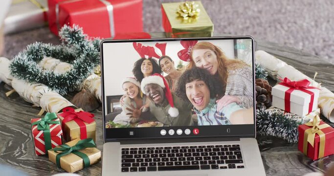 Animation of diverse friends on laptop video call at christmas