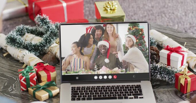 Animation of diverse friends on laptop video call at christmas