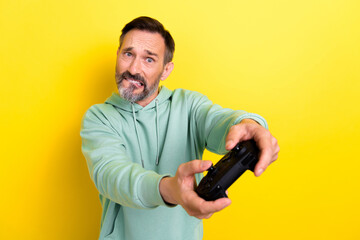 Portrait of stressed depressed man have free time home bite lips tense level cant complete hard game isolated on yellow color background