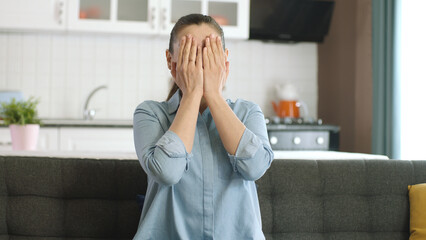 Confused excited woman open face looking at camera with big eyes in surprise, shocked. Oh my god wow! Woman covers hands with palms, hides face, plays hide and seek.