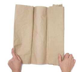 Two female hands hold a roll of crumpled brown paper on a white background, top view