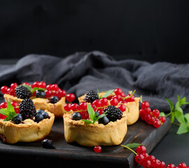 Ripe red cherries in a plate on a white table, close up