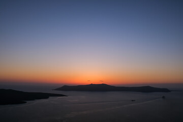 Panoramic view of the caldera, the volcano of Santorini and a beautiful colourful sky