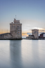 La rochelle harbor at sunset. Panorama skyline. the famous towers of La Rochelle are illuminated with christmas light.