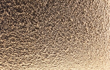 Fondo con detalle y textura de superficie rugosa con degradado de luz y tonos marron 