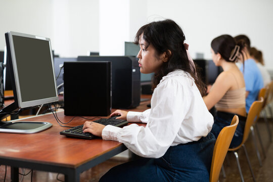 Teen Schoolgirl Learning Basics Of Programming In Group Course In Computer College