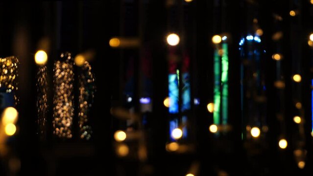 Christmas Lights Defocused With Silhouettes of People Walking
