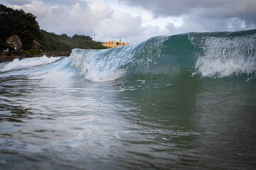 Close-up view of wave breaking on the beach shore.