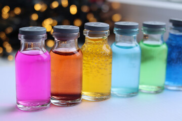 Glass jars with alcohol solutions of indicator dyes.