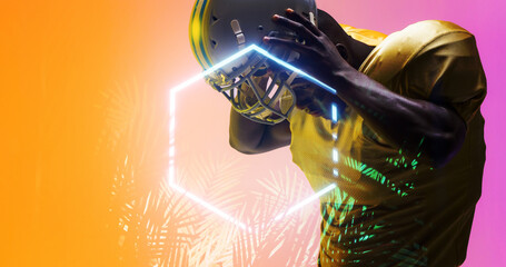 Composite of american football player removing helmet by illuminated hexagon and plants, copy space