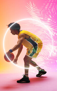 Composite of biracial basketball player dribbling ball by illuminated circle and plants, copy space
