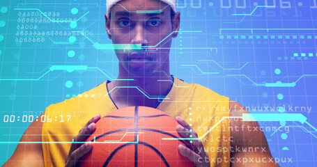 Naklejka premium Portrait of biracial basketball player holding ball over grid pattern with computer language