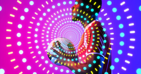 Illuminated colorful dots and lines over side view of african american male player with soccer ball
