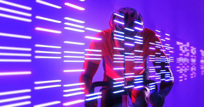 Illuminated lines over african american male athlete riding bike over blue background - Powered by Adobe