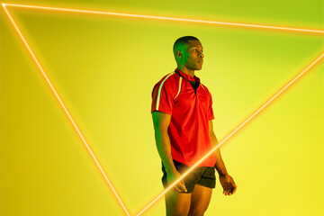 Triangle neon over thoughtful african american young sportsman standing against yellow background