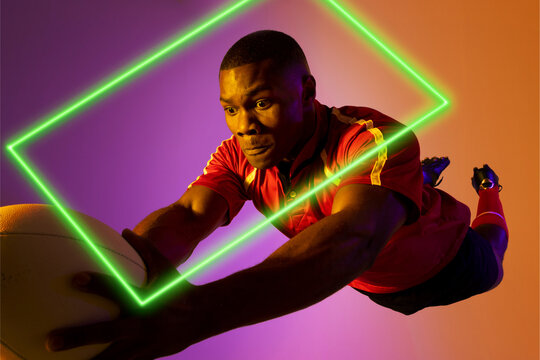 Rectangle neon over african american young rugby player jumping against colored background