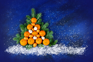 Christmas tree made of tangerines and walnuts