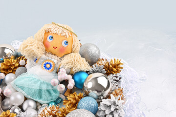 Greeting Christmas card with a handmade angel on a silver background