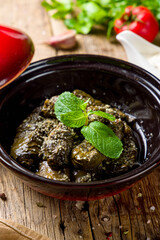 Dolma georgian kitchen with meat and mint on wooden table vertical