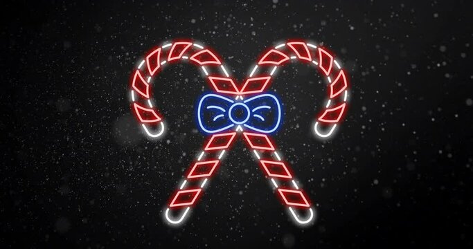Animation of snow falling over christmas candy canes