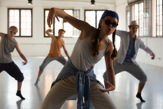 Team Of Young Dancers Training Street Dance Moves And Having Fun