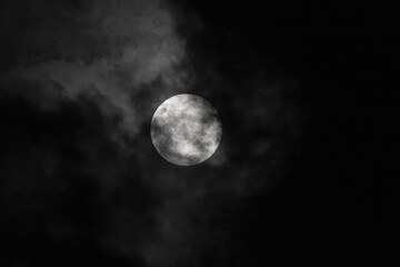 Fototapeta na wymiar full moon covered by clouds