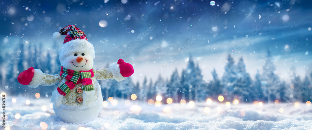 Canvas Prints snowman on snow in winter forest with snowfall in defocused landscape and abstract lights