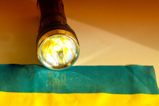 Ukrainian flag and flashlight in Ukraine. A symbol of the steadfastness of the Ukrainian people.