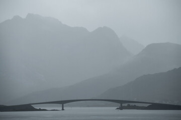 Fototapeta na wymiar Fredvang bridge in misty rain, Lofoten Islands, Norway