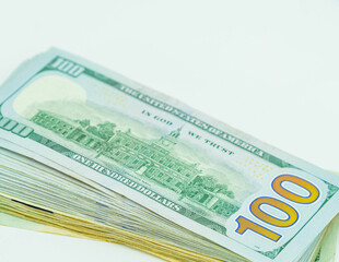 Stock of hundred dollar bills on white background.