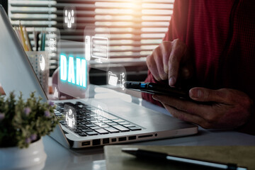 DAM, Digital Asset Management Organization Concept, Person hand using smart phone on office desk with DAM icon  on virtual screen.