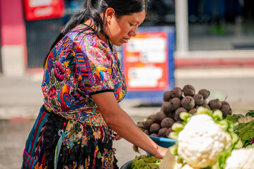 Vendedora en un mercado de vegetales frescos en Guatemala. 