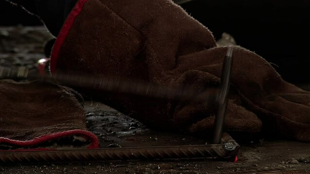 Male Blacksmith Shaping Metal with Hammer. Close Up. 