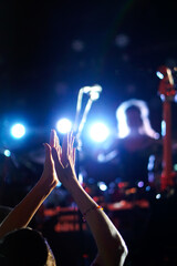hands in the air at an indoor concert venue